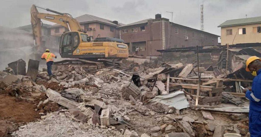 a bulldozer clearing a residential plot, government land acquisition context, Nigerian setting